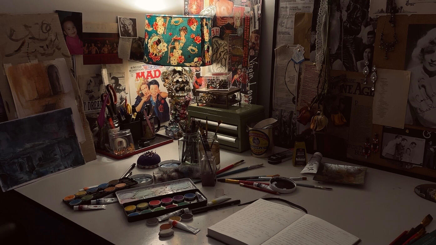 Studio workspace showing painting materials, sketchbooks and collected objects used throughout Jade JennaLee’s practice.